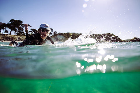 Guy surfing in Australia wearing Vilo Wooden Sunglasses